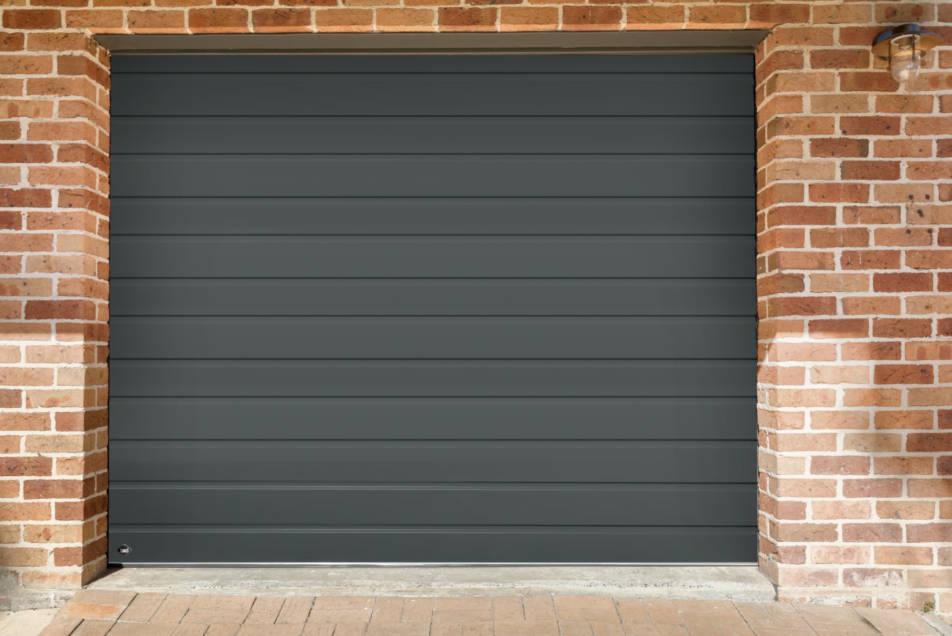 B&D Roll-A-Door Neo in a dark finish fitted to a brick garage opening