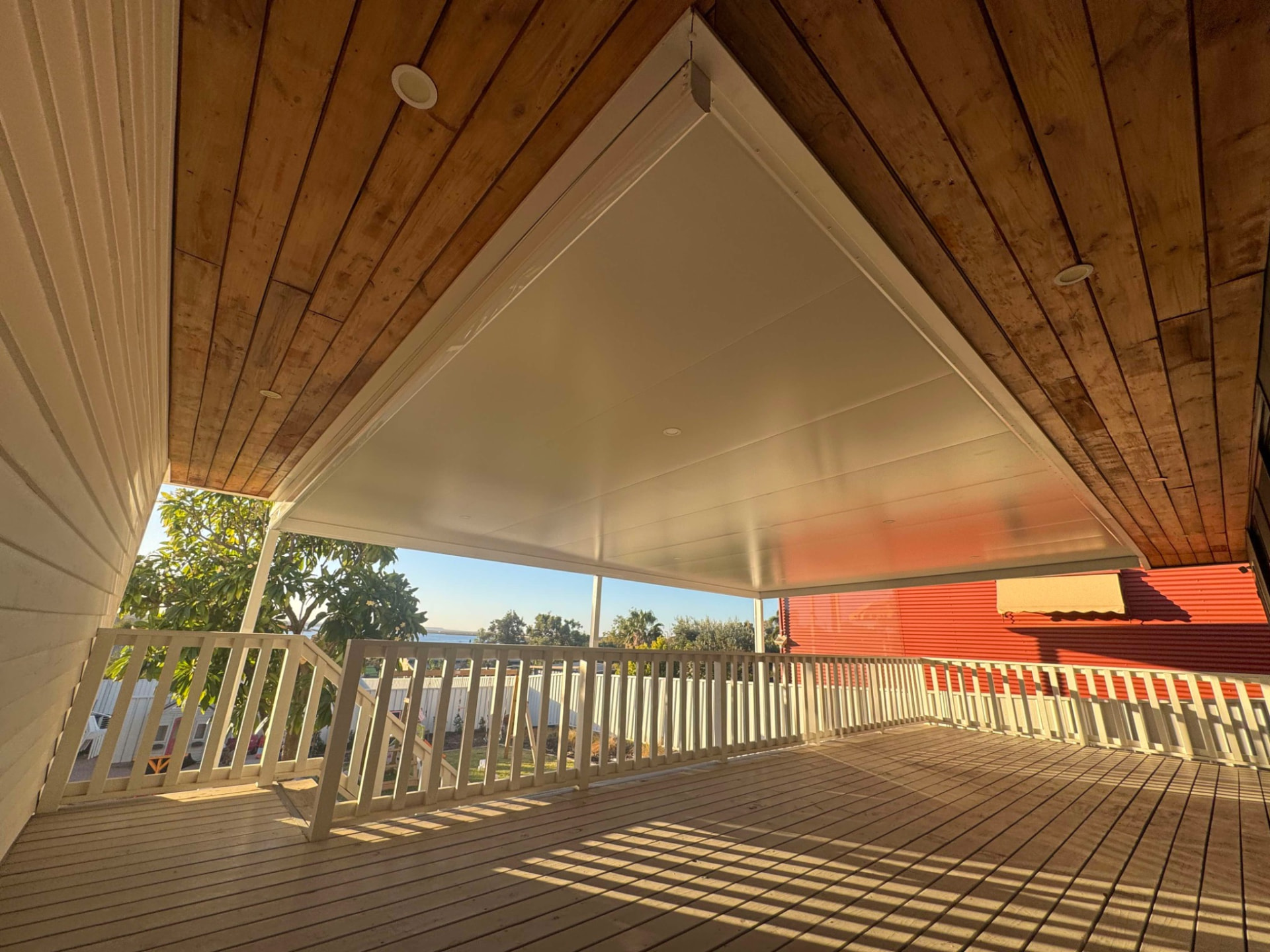 Insulated verandah roof above a timber deck with balustrade and timber-lined ceiling