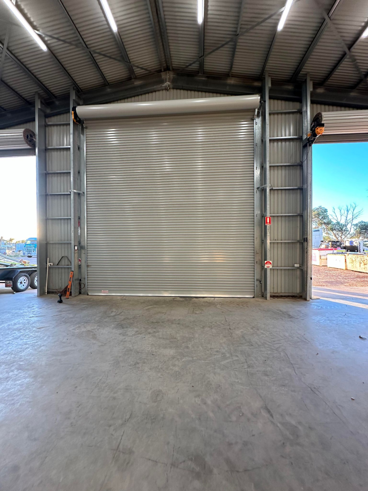 Industrial door being installed into a large commercial building opening