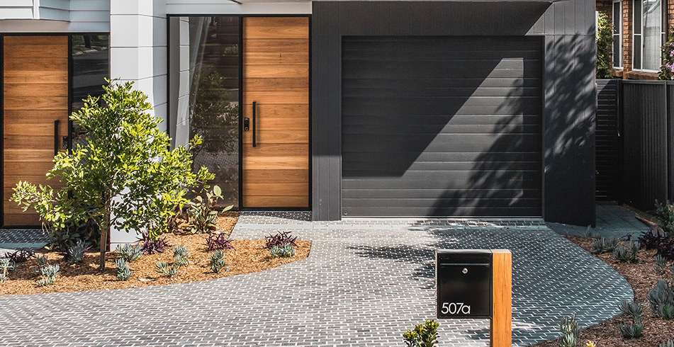 B&D Panelift sectional garage door in Monument woodgrain on a contemporary home entry