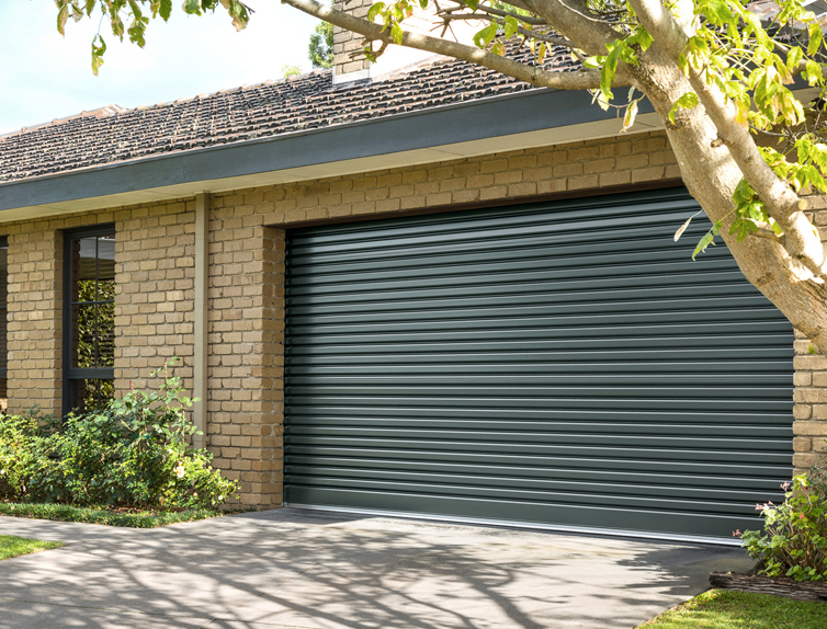 B&D Roll-A-Door Traditional roller garage door in a dark grey finish on a brick home