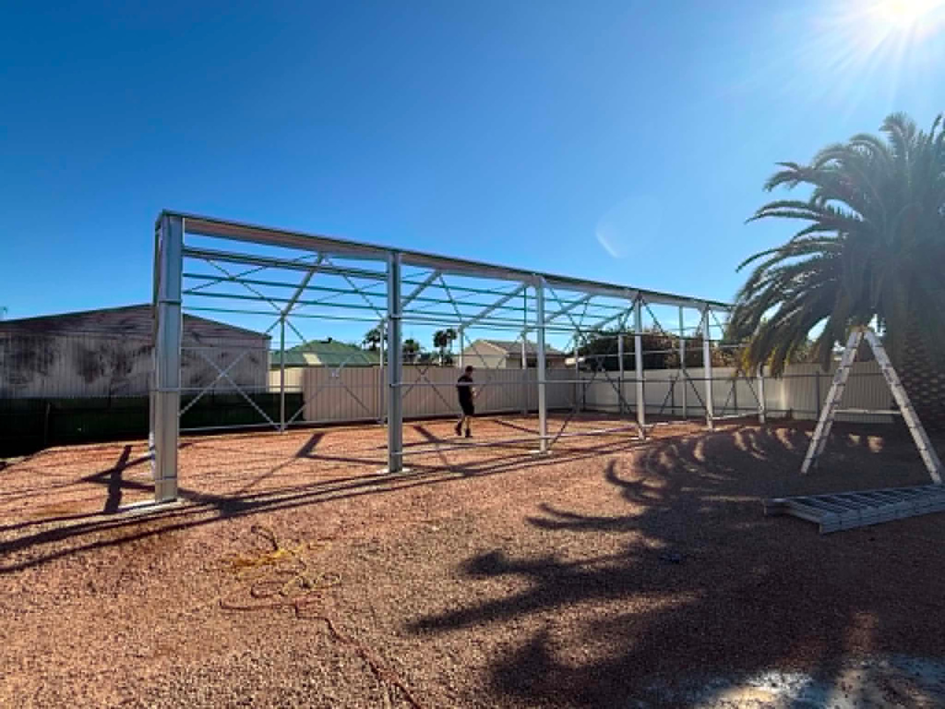 Steel shed portal frame erected on a prepared pad during construction